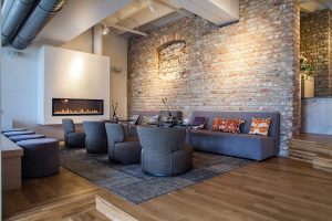 Soft, warm lighting illuminating a brick living room.