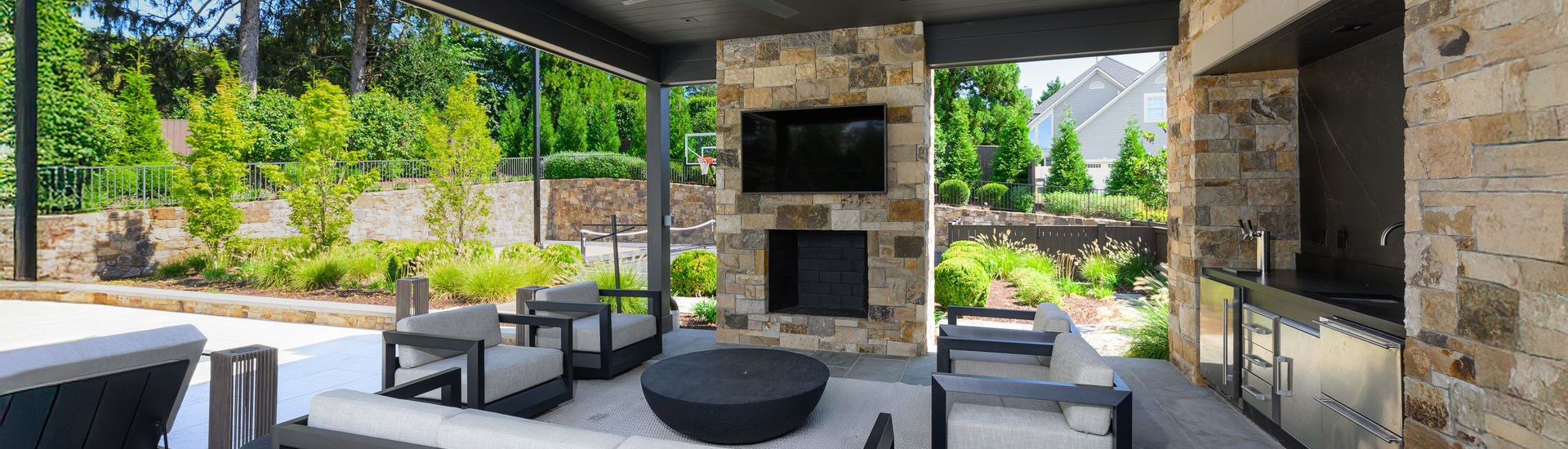 Covered outdoor living area with television and seating